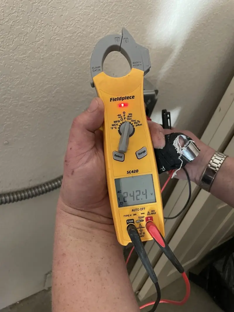 Voltage testing with clamp meter during Whole House Surge Protector in Elwood